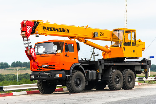 Chelyabinsk region, Russia - July 21, 2012: Off-road mobile crane Kamaz 43118 is parked at the interurban road.