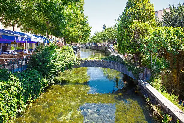 L'Isle-Sur-La-Sorgue, a small typical town in Provence, France. Beautiful village, with view on roof and landscape, small cafe and restaurants.