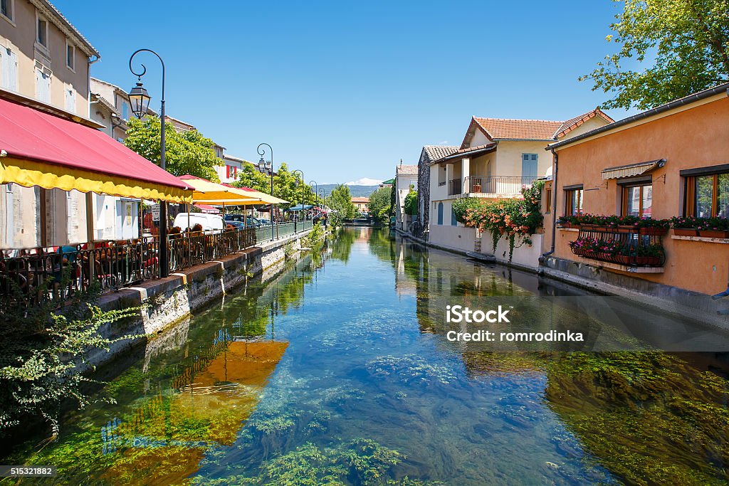 L'Isle-Sur-La-Sorgue, small typical town in Provence, France L'Isle-Sur-La-Sorgue, a small typical town in Provence, France. Beautiful village, with view on roof and landscape, small cafe and restaurants. L'Isle-sur-la-Sorgue Stock Photo
