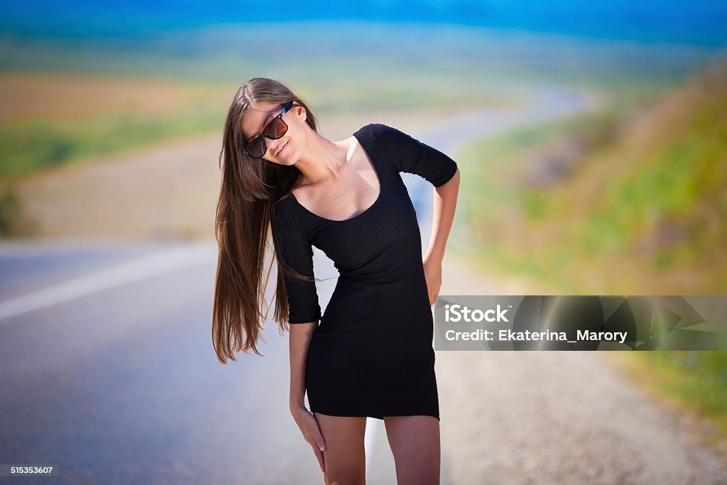 brunette woman road beautiful  brunette  sexy  woman in black dress and sunglasses  go road has long hair  and elegant body Adult Stock Photo