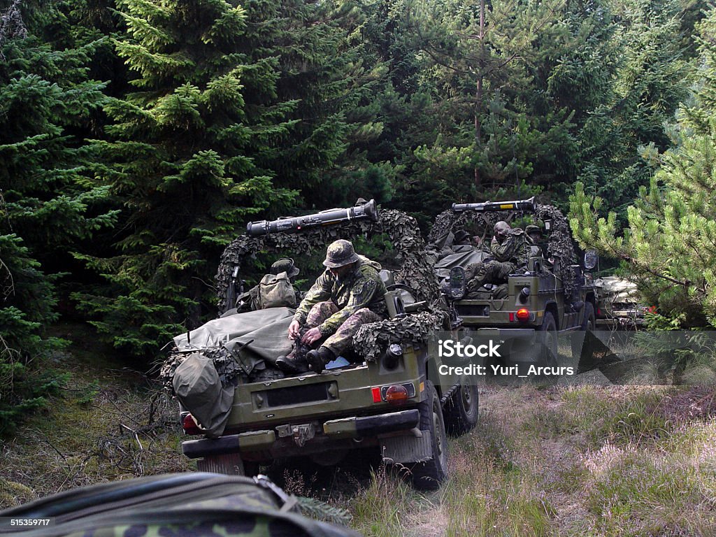 On patrol with a formidable army platoon Shot of a platoon on patrol in the woods - This is the real thing from KFOR, Kosovo 1999. This image is part of our historic collection. The digital cameras available back then where very bad, so expect exceptionally bad image quality Military Stock Photo