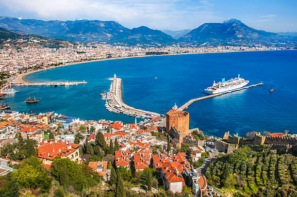 Cityscape of Alanya/Turkey Alanya, Turkey-March 13, 2016: Alanya is a touristic centre on Turkeys Mediterranean coast, 135 kilometers east of Antalya. Excavations have shown that the Alanya area was inhabited as early as prehistoric times. Alanya first appears in the 2nd century B.C. as a pirate lair and it was known then as Korakesion. The Romans later captured the town in their campaign to suppress piracy in the eastern Mediterranean. Alanya is a touristic centre on Turkeys Mediterranean coast. alanya stock pictures, royalty-free photos & images