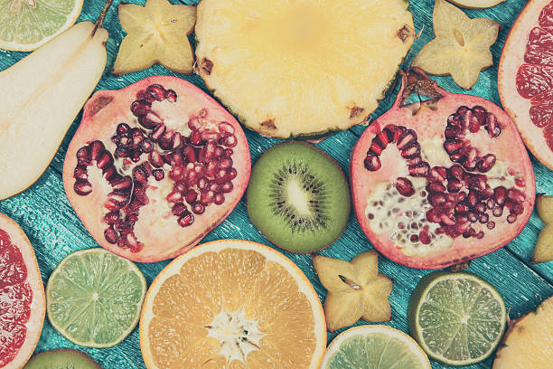 istock Colorful fruit slices on blue wood surface 515366170