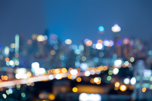 Night blurred bokeh lights city downtown, abstract background