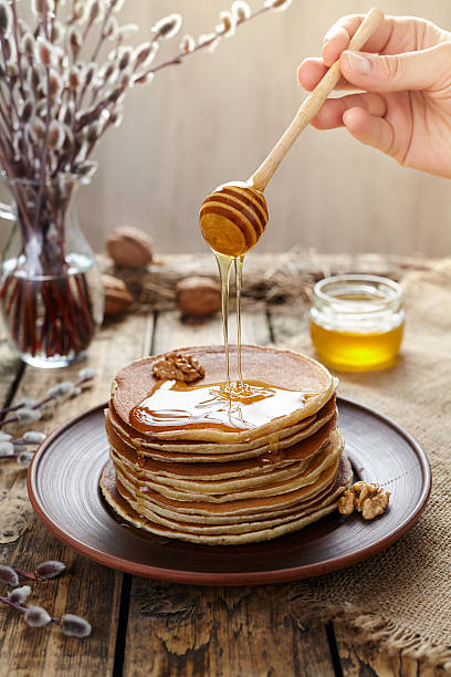 istock Flowing honey on stack of traditional american pancakes 515369418