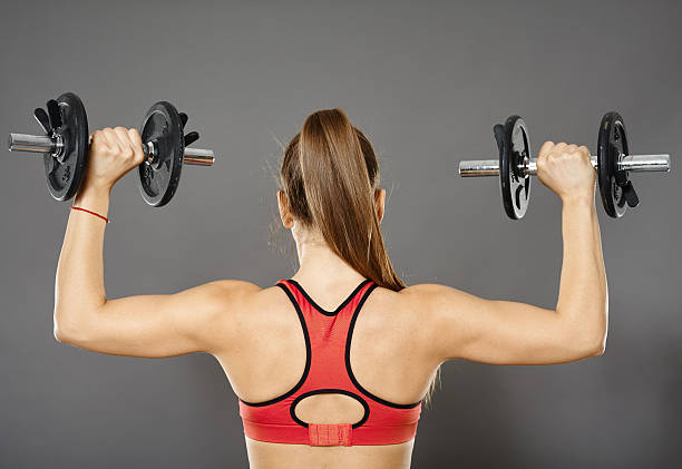 istock Fitness girl working with weights 515369946