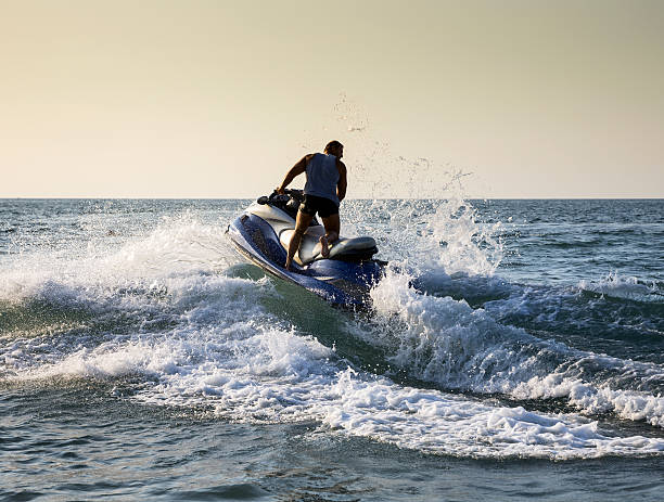 istock Silhouette of man on jetski at sea 515379716