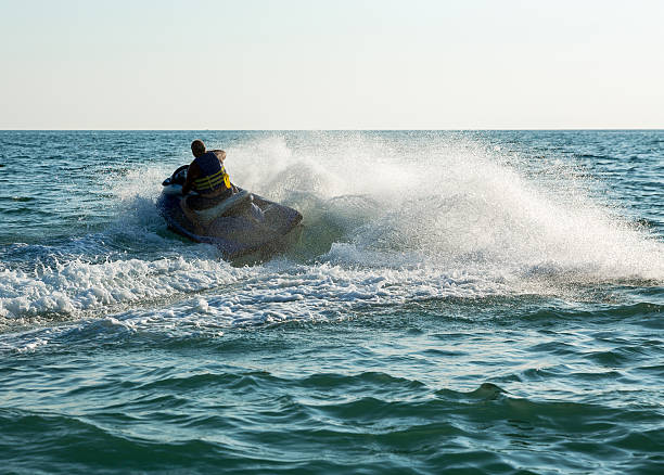 istock Silhouette of man on jetski at sea 515379820