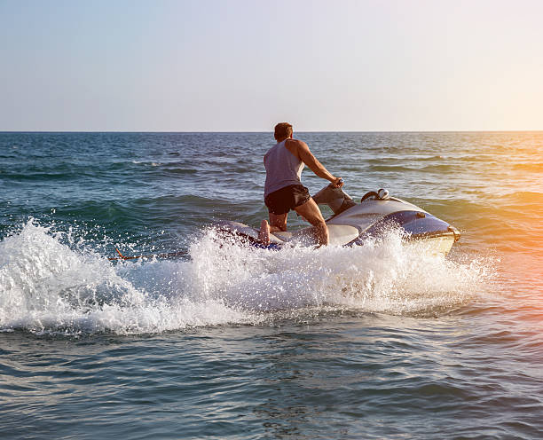 istock Silhouette of man on jetski at sea 515379912