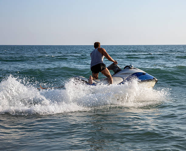 istock Silhouette of man on jetski at sea 515380152