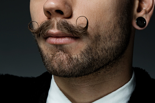 close up of young man with long moustaches
