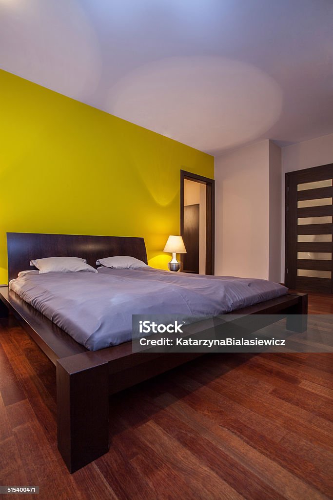 Big bed in modern bedroom Big bed in a modern bedroom, vertical Apartment Stock Photo