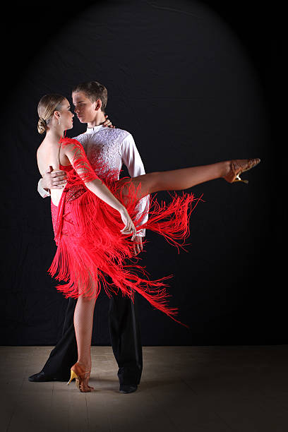 istock Latino dancers in ballroom against on black 515400537
