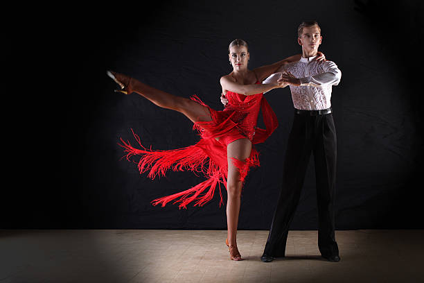 istock Latino dancers in ballroom against on black 515400541