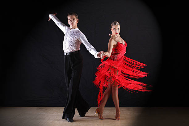 istock Latino dancers in ballroom against on black 515400559