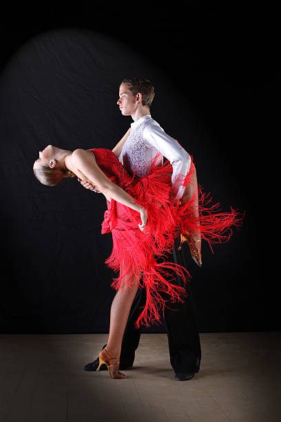 istock Latino dancers in ballroom against on black 515400569