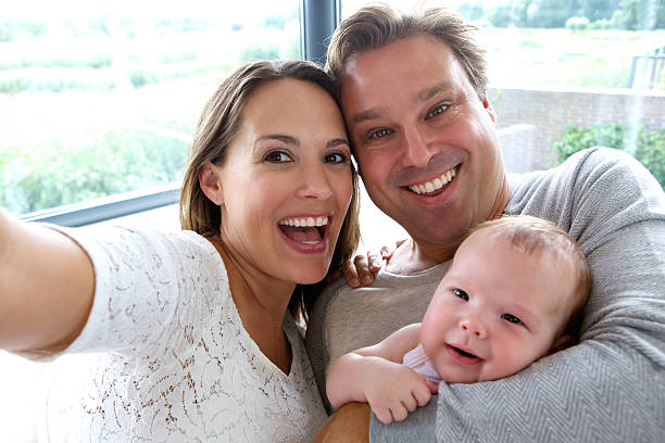 istock Happy couple taking a selfie with baby 515400637
