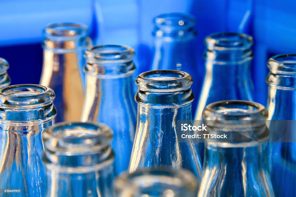 Empty bottles Empty glass bottles in a blue plastic crate. Bottle Stock Photo