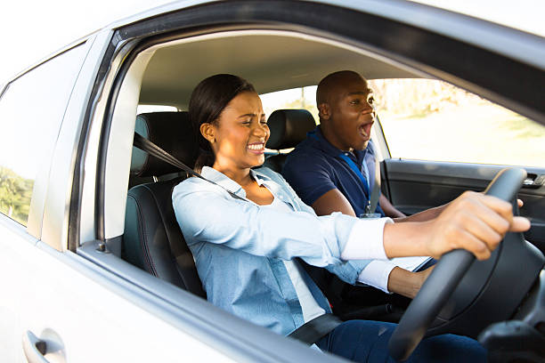 istock african girl taking driving lessons for the first time 515402317