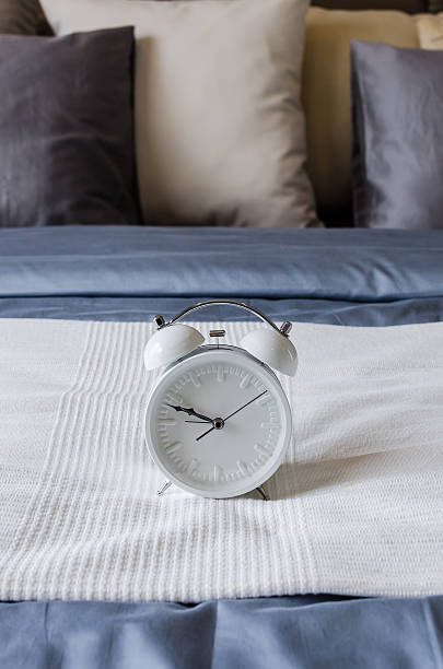 istock modern white alarm clock in bedroom 515403167