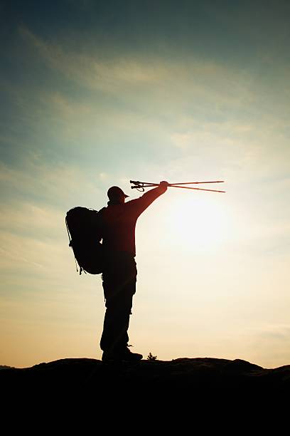 istock Alone man backpacker at sunrise at open view on peak 515435132