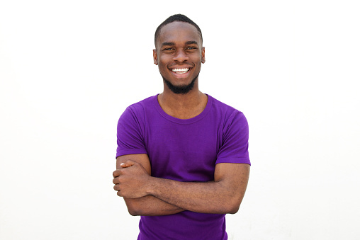 Portrait of an smiling young man in purple t-shirt on white background