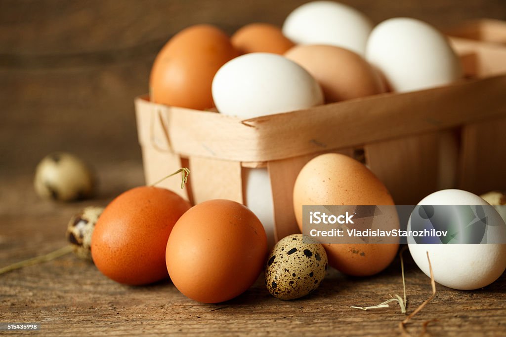 Chicken and quail eggs on a wooden rustic background Fresh chicken and quail eggs on a wooden rustic background Animal Egg Stock Photo