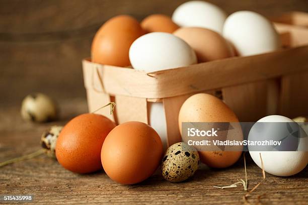 Chicken And Quail Eggs On A Wooden Rustic Background Stock Photo - Download Image Now