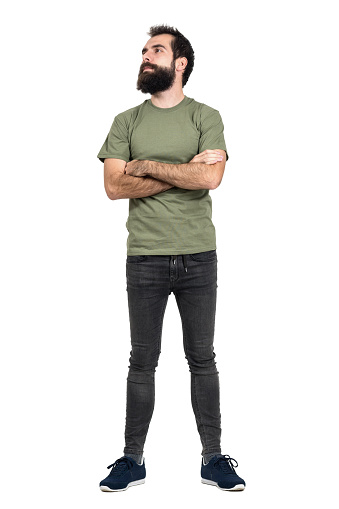 Proud confident bearded man with crossed arms looking up. Full body length portrait isolated over white studio background.