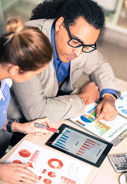 istock Successful young entrepreneurs analyzing stock market data in office 515437010