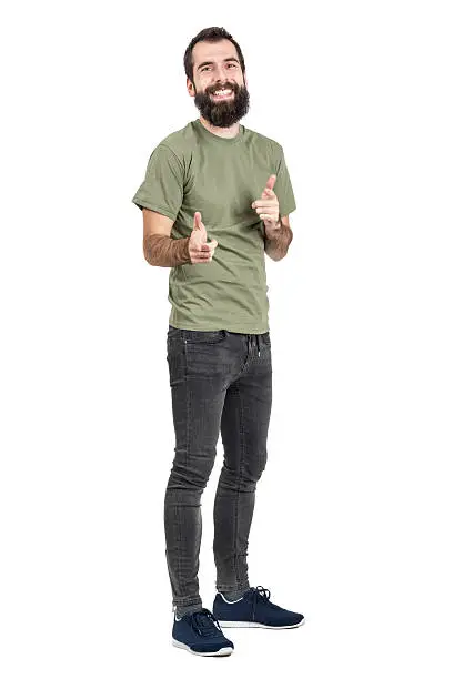 Photo of Spontaneously laughing man in green t-shirt pointing fingers at camera