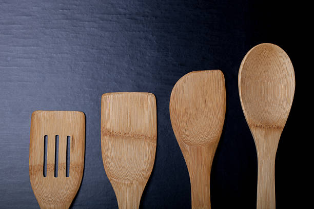istock Wooden cooking tools on a black background 515441028