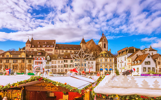 The landmark Barfüsserplatz and Christmas stalls in Basel (Switzerland) on a beautiful winter day.