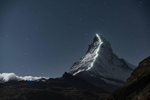 Matterhorn at Night The Matterhorn mountain from Zermatt, Switzerland. Photographed at night, the lights are lanterns that follow the route the first explorers took to reach the peak. matterhorn stock pictures, royalty-free photos & images