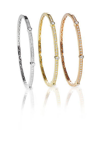 istock Set of three colored gold diamond bangle bracelets standing upri 515445184