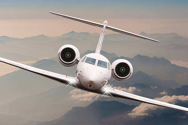 istock Airplane fly over clouds and Alps mountain on sunset. Front 515446572