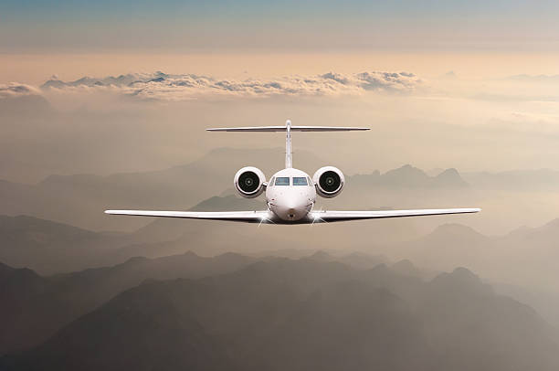 istock Airplane fly over clouds and Alps mountain on sunset. Front 515447302