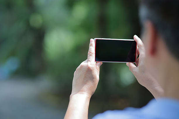 istock Asian man taking picture outdoor 515447358