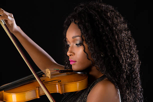 istock Woman with violin in dark room 515447598