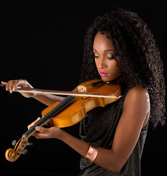 Woman with violin in dark room