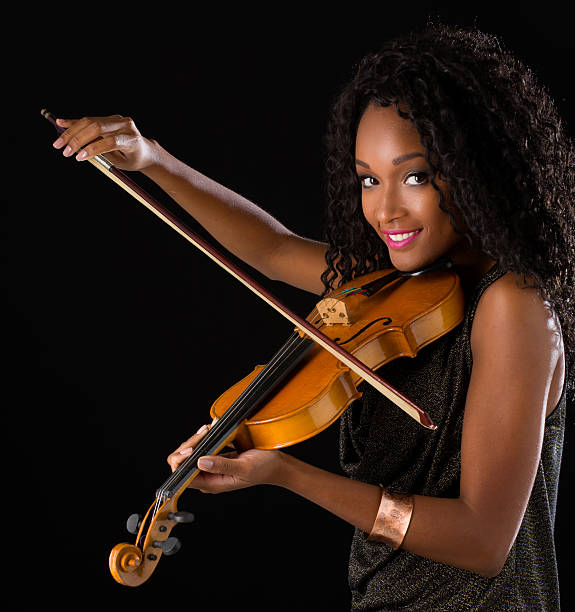 istock Woman with violin in dark room 515447670