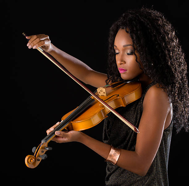 istock Woman with violin in dark room 515447714
