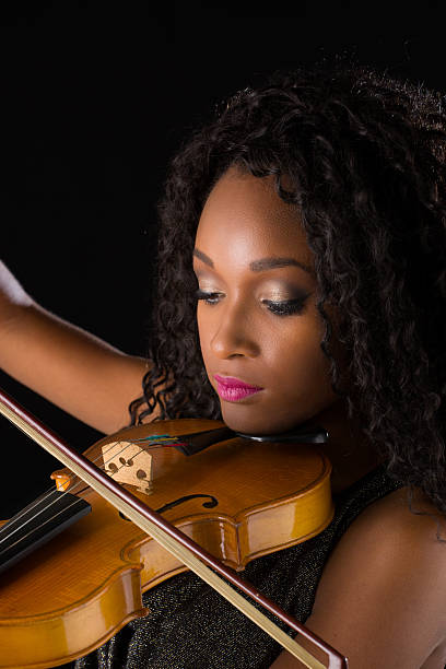 istock Woman with violin in dark room 515447770