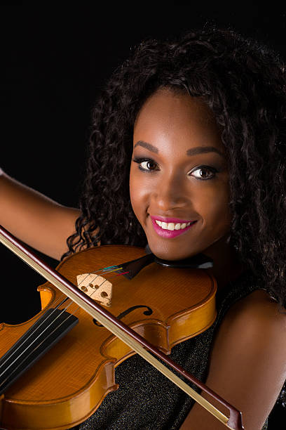 istock Woman with violin in dark room 515447832