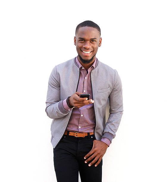 istock Handsome young african man standing with a mobile phone 515448146
