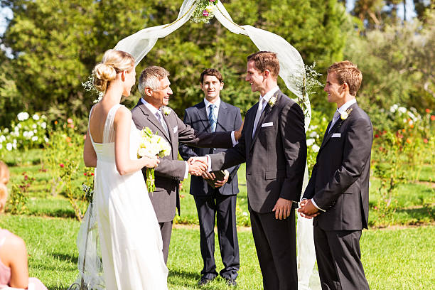 istock Father Shaking Hands With Groom During Wedding Ceremony 515449013