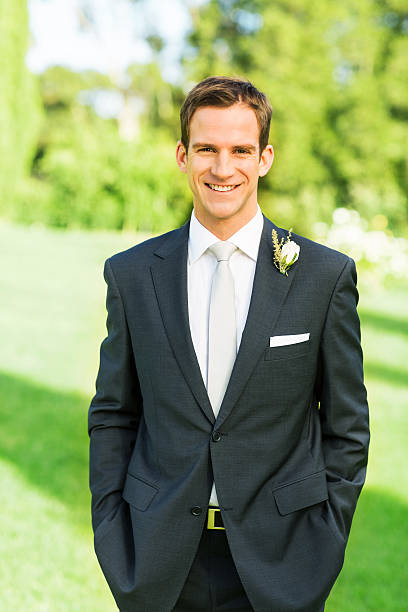 istock Happy Groom Standing With Hands In Pockets In Garden 515449023