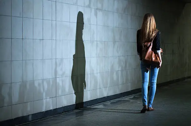 Photo of Woman walking alone at night