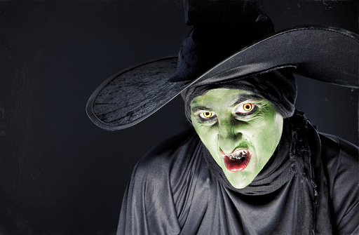 A wicked witch sneering at the camera.