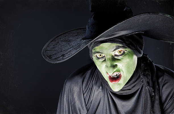 Sneering Witch A wicked witch sneering at the camera. ugly face stock pictures, royalty-free photos & images